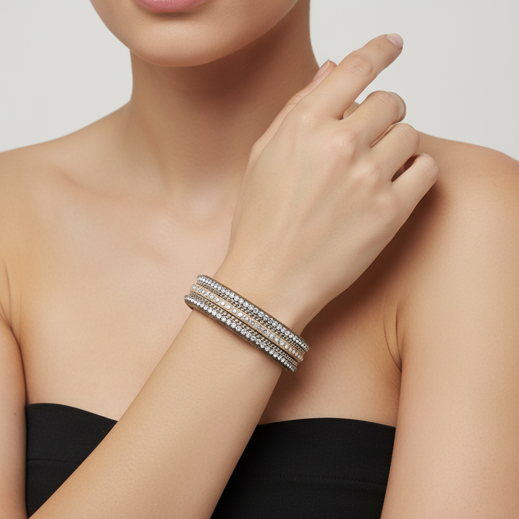 A tan leather bracelet with three rows of silver rhinestones, displayed on a bamboo ring sizer measuring 6.5 inches.